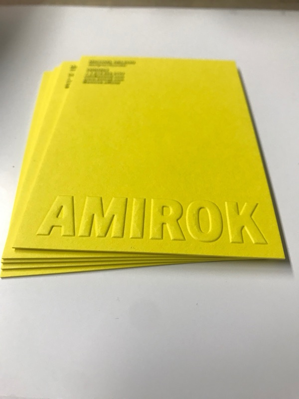 Amirok yellow hang tags with embossed lettering