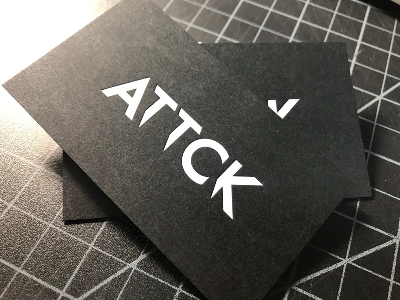 ATTCK white foil wordmark on black card