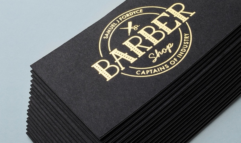 Gold foil barber shop cards on black, stacked