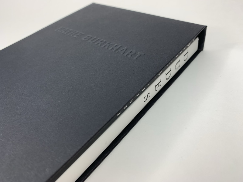 Thick black casebound book with silver page edges