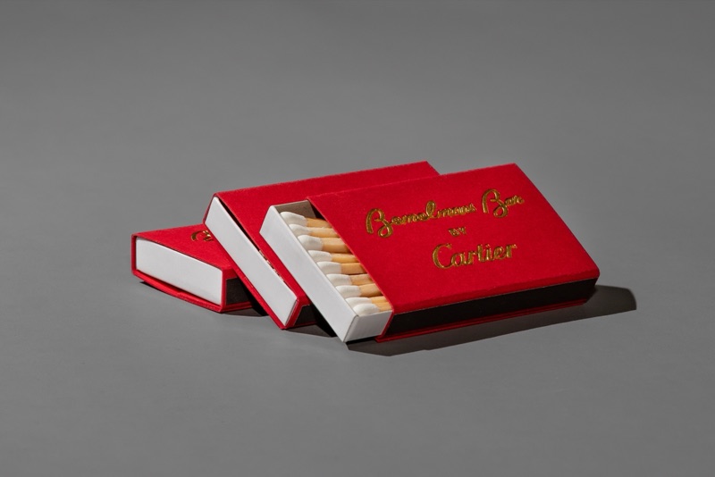Cartier branded matchboxes stacked with loose matches