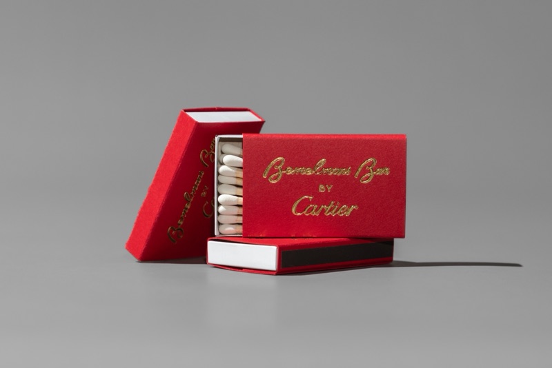 Cartier red matchboxes with gold foil, one slid open