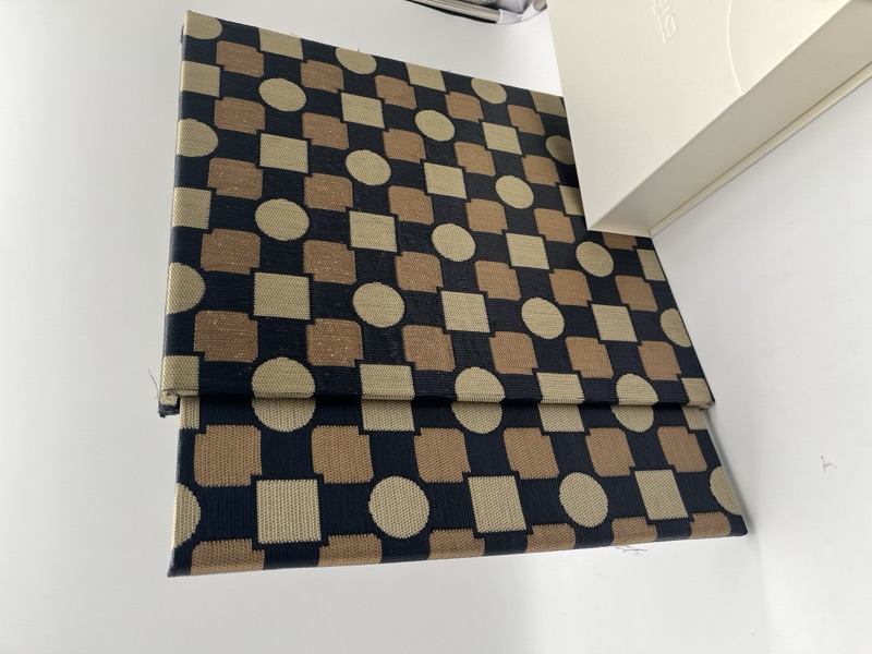 Casebound book wrapped in checkerboard cloth
