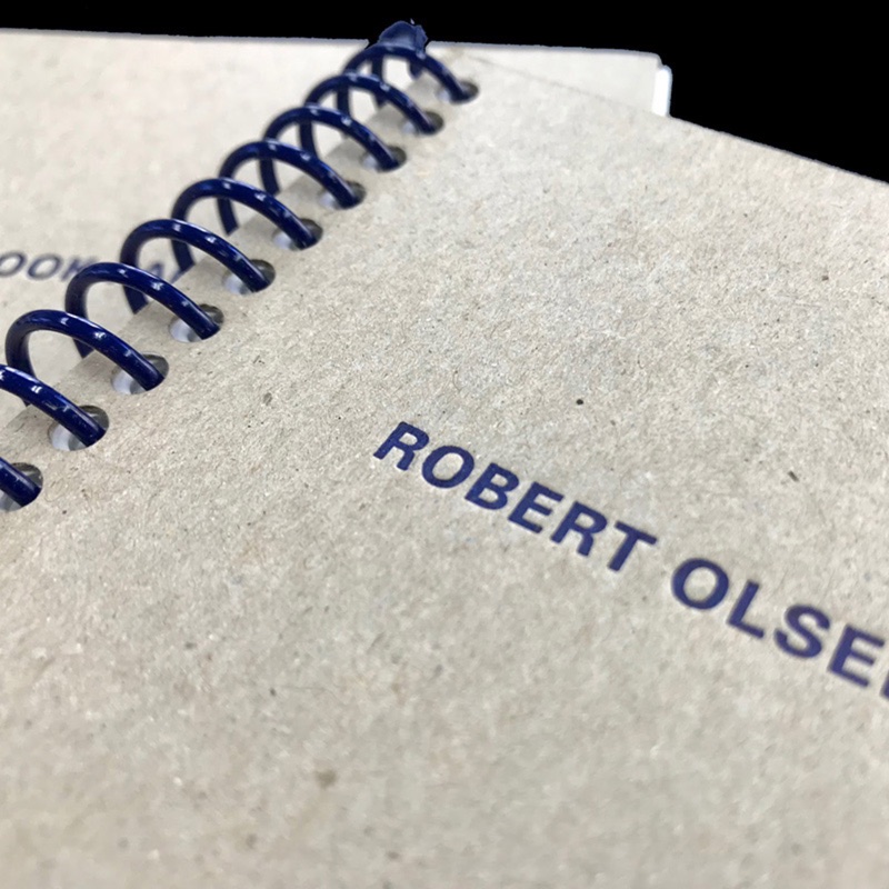 Letterpress chipboard cover with blue coil binding