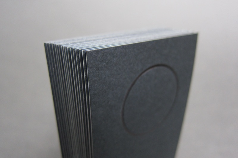 Stack of black cards with clear foil circle motif