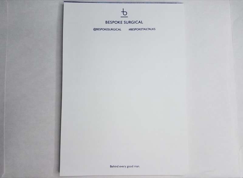 Company stationery and notebooks in offset blue on grey paper