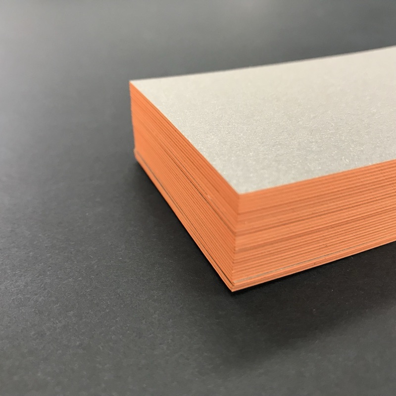 Cream card stack with orange painted edges