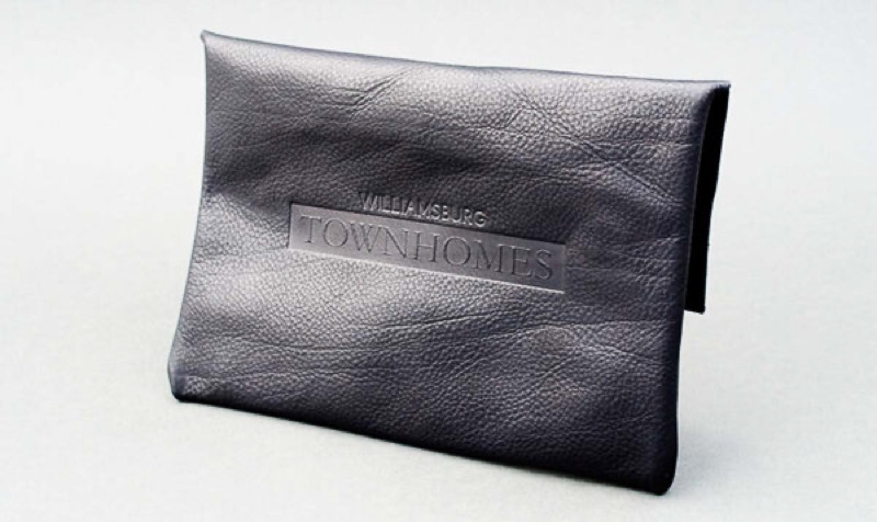 Debossed logo on textured leather pouch