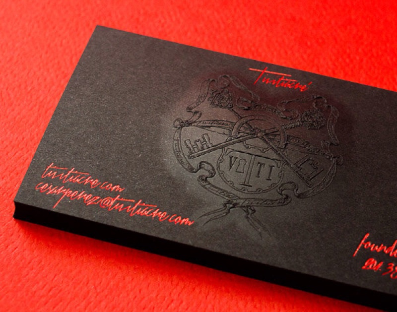 Embossed logo on a black paper business card