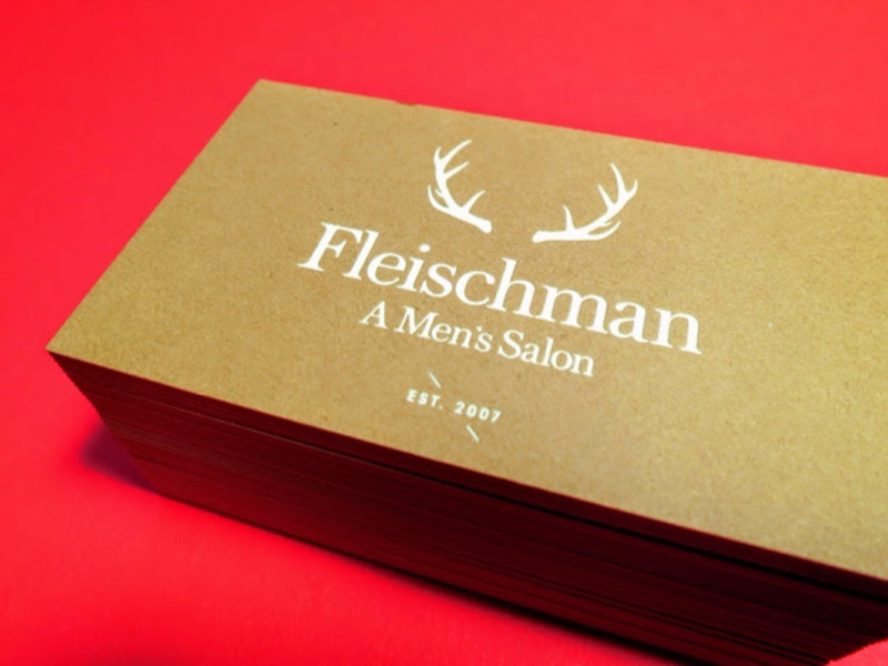 Fleischman salon kraft cards with gold antler mark, stacked on red