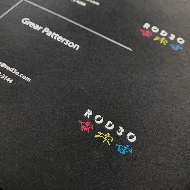 Fluorescent ink on black paper business cards
