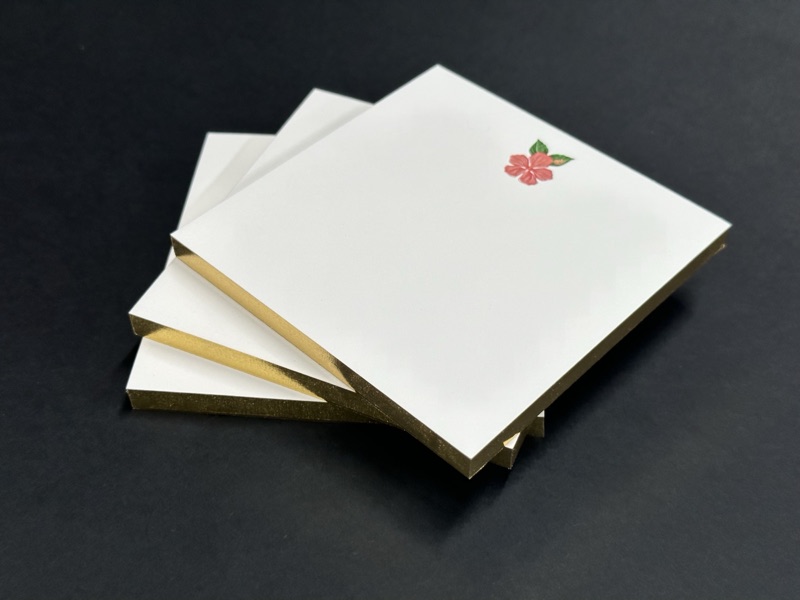 Notepads with gilded edges and letterpress flower