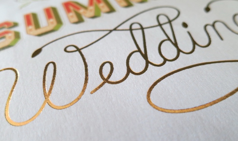 Wedding invitation with hand-lettered gold foil script