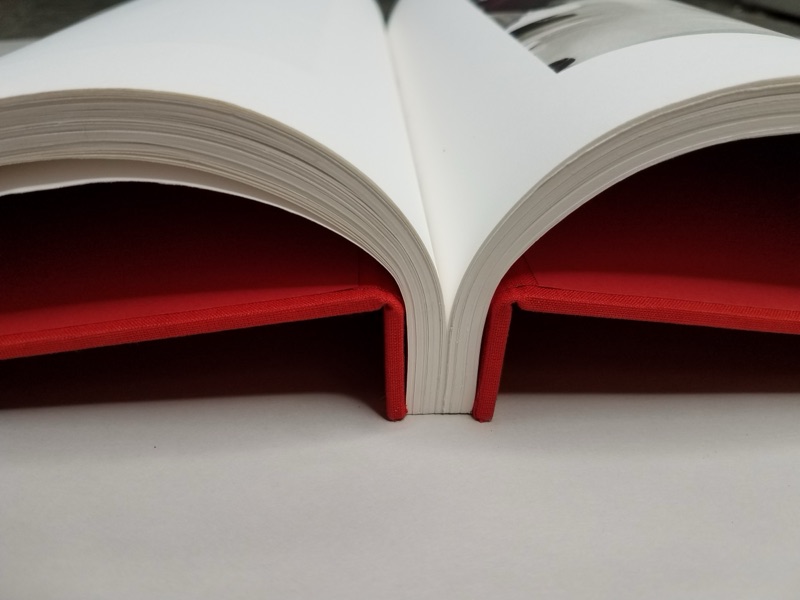 Grommet-bound book detail with cloth wrap and exposed spine