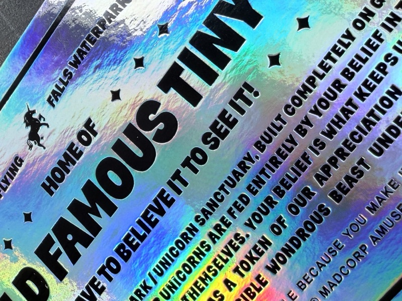 Holographic event pass with black type