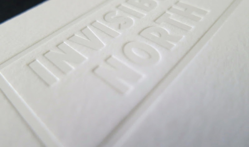 Invisible North extra-thick card with deep deboss lockup