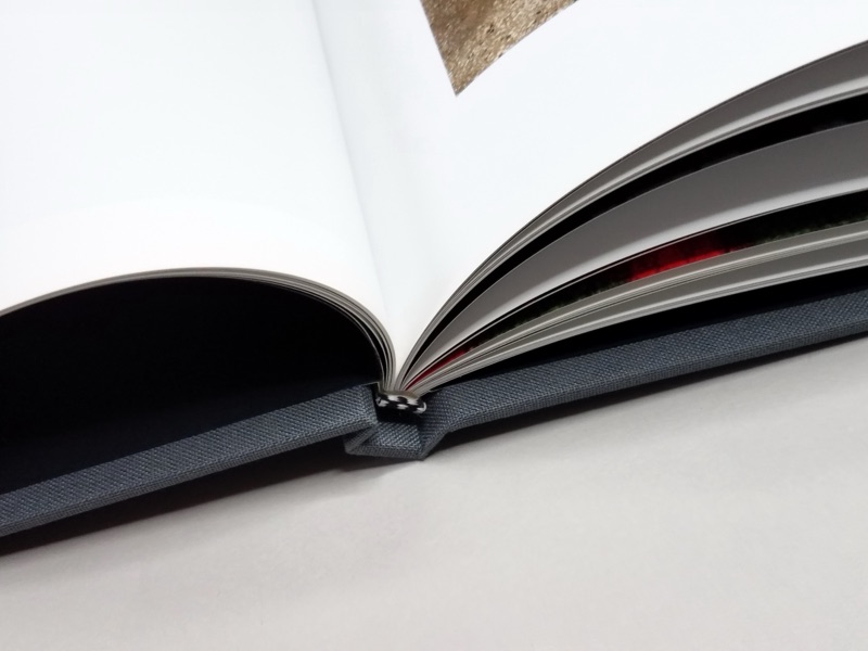 Linen-wrapped hardback opening to a coated full-color spread