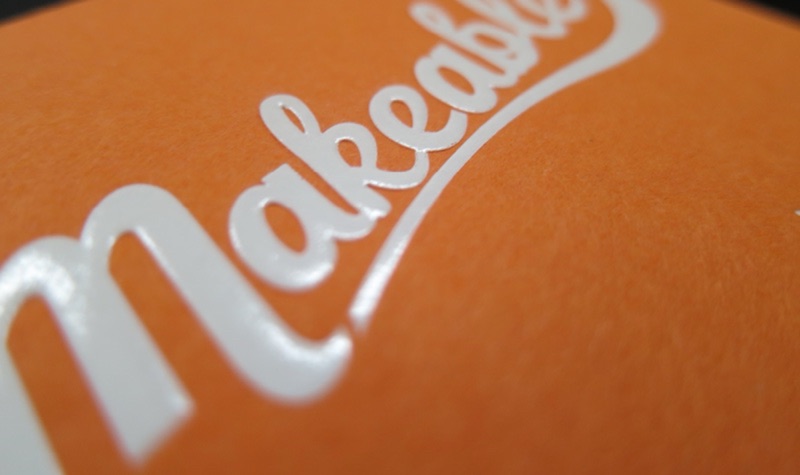Makeable raised gloss script on orange card