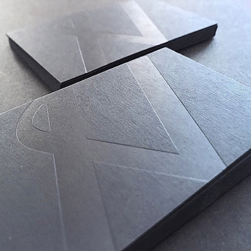 Matte black business cards stacked