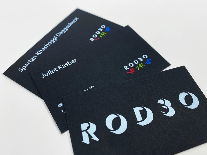 Neon fluorescent business card on black paper