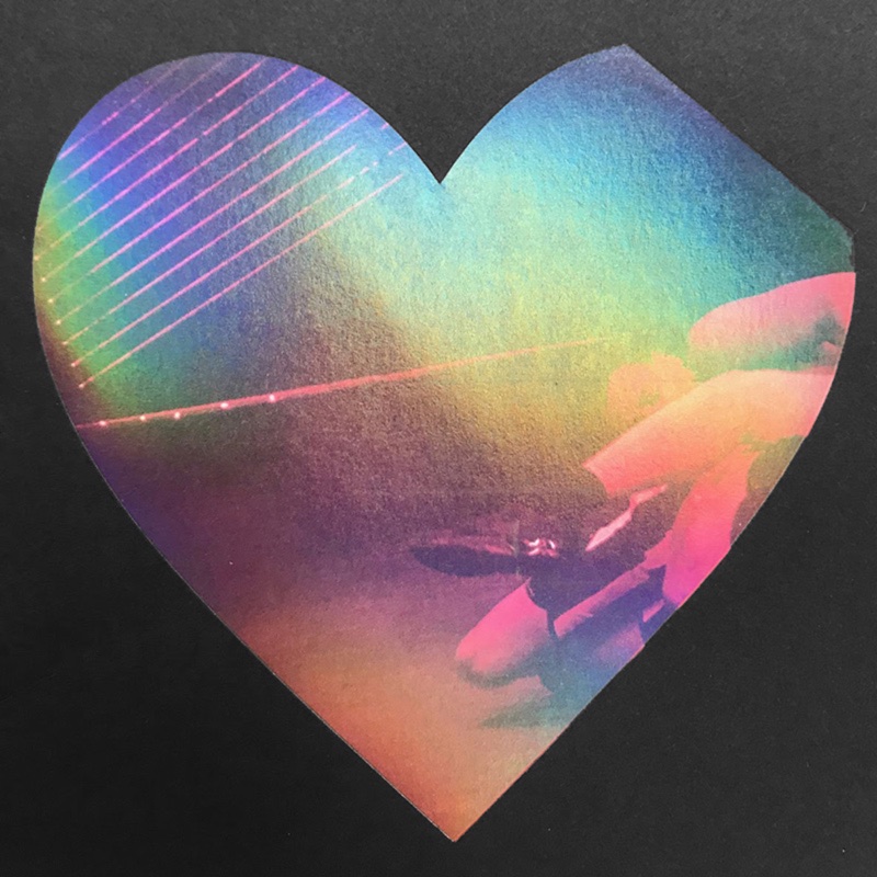 Rainbow hologram heart on black card
