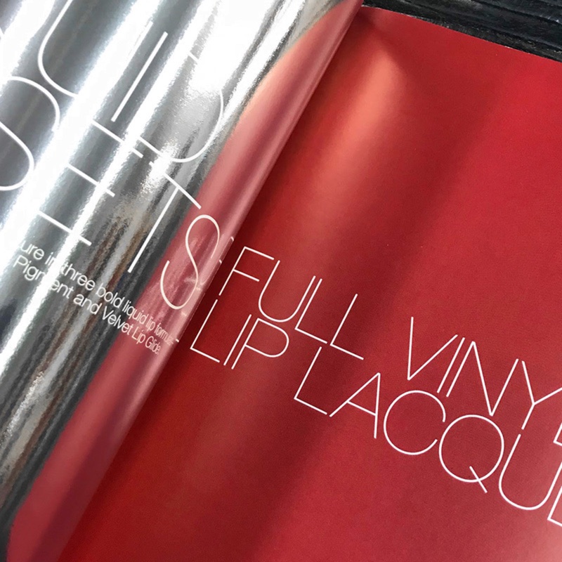 Lookbook page in glossy red vinyl with white type