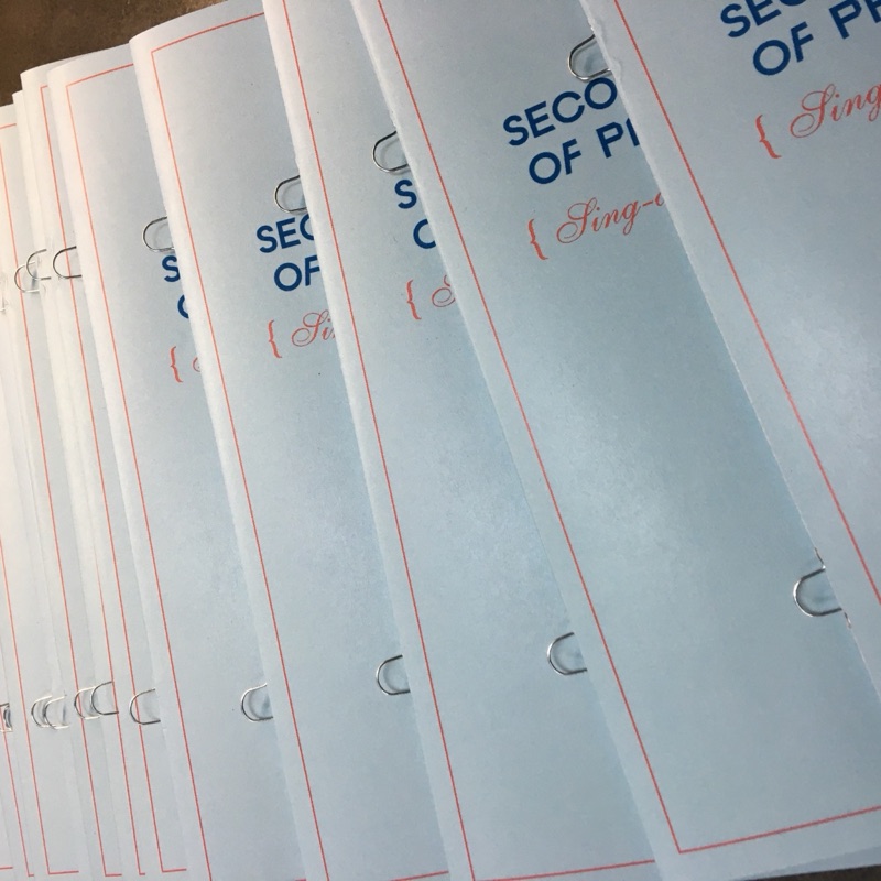 Ring-bound menu pages in silver with red rule frames