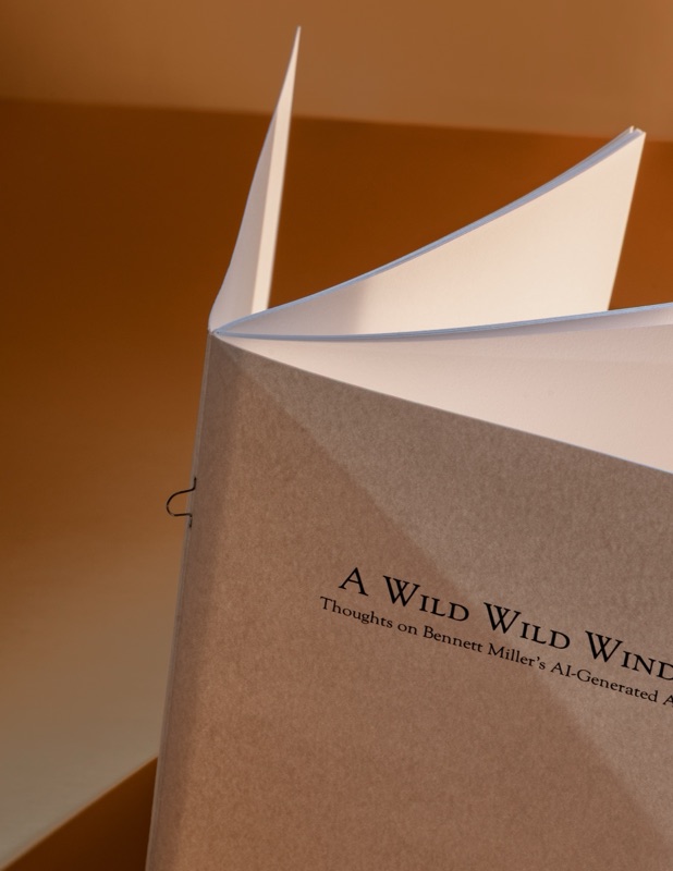 Saddle-stitched kraft booklet standing open on its staples
