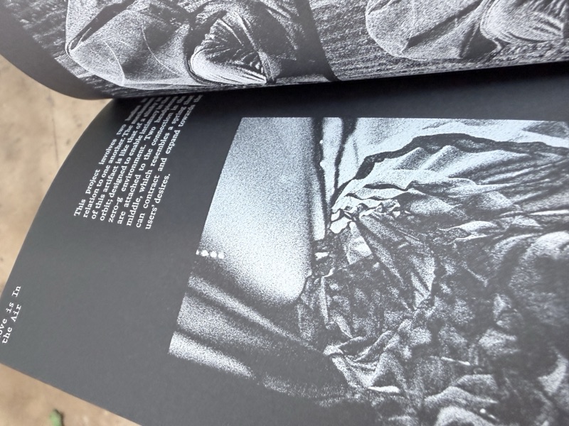 Silver ink art book spread on black paper