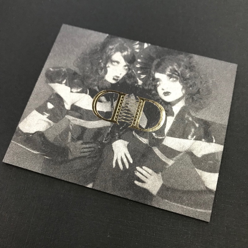 Silver metallic ink business card on black stock