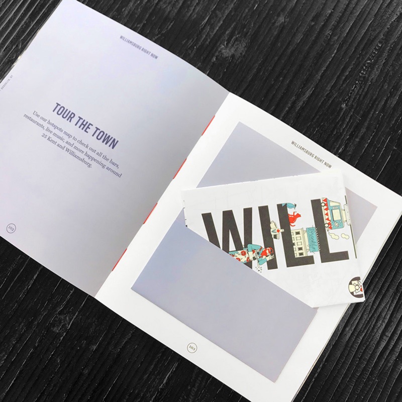 Smyth-sewn book opening flat with tipped-in postcards