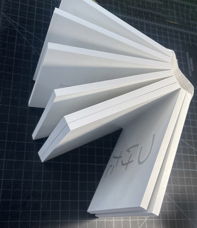 Extra-thick perfect-bound book fanned open