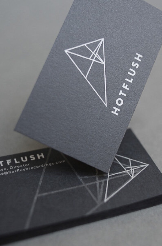 White and silver ink on black business card