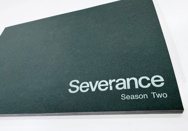 White ink and CMYK book cover on colored paper